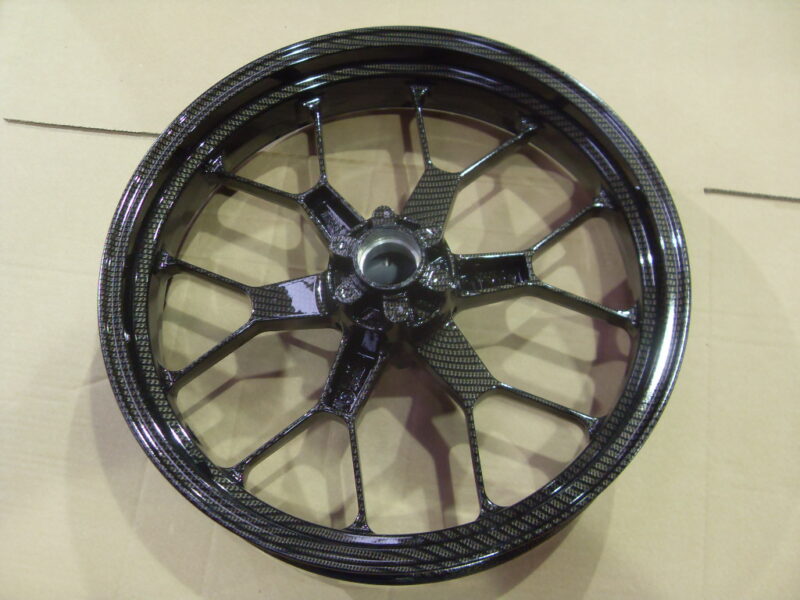 Motorbike alloy wheels coated in carbon fibre painted black