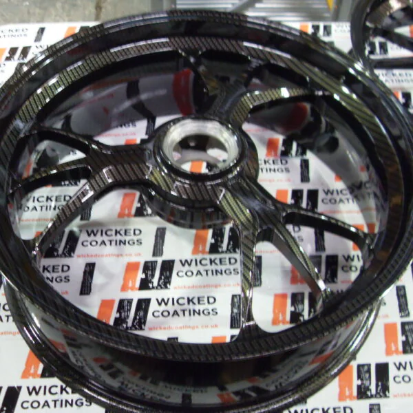 Motorbike alloy wheels coated in carbon fibre painted black