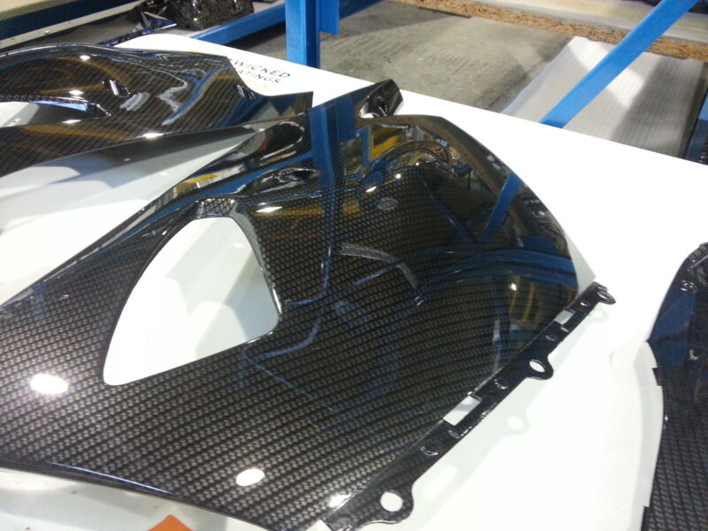 Motorbike parts coated in carbon fibre hydrographic film painted black