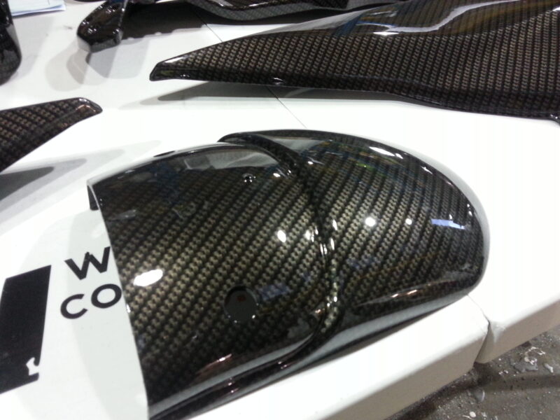Motorbike parts coated in carbon fibre hydrographic film painted black