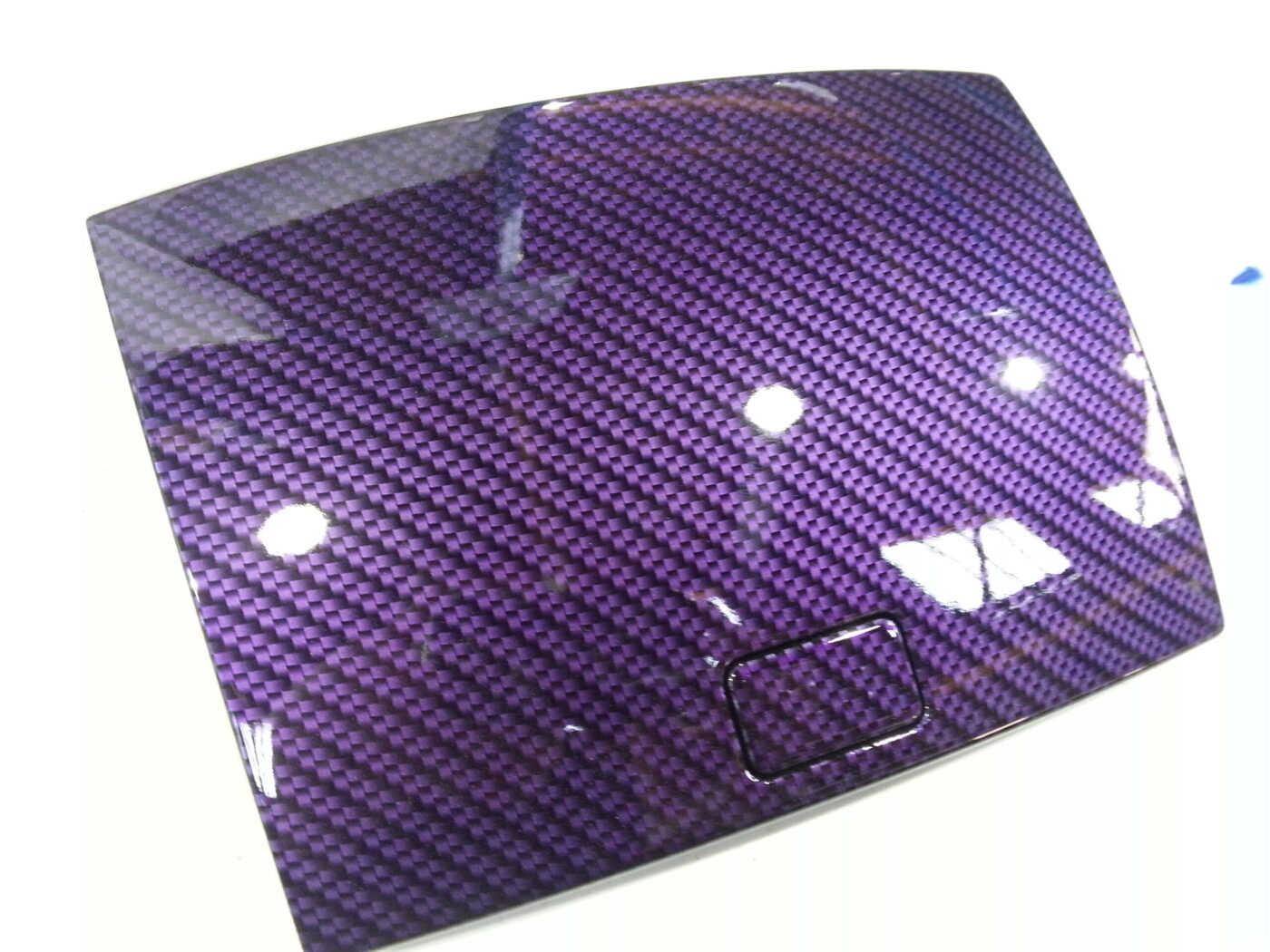 Car dashboard elements coated in carbon fibre hydrographic film painted purple