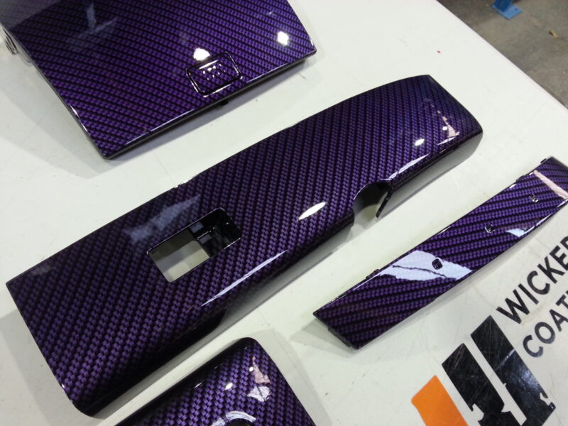 Car dashboard elements coated in carbon fibre hydrographic film painted purple