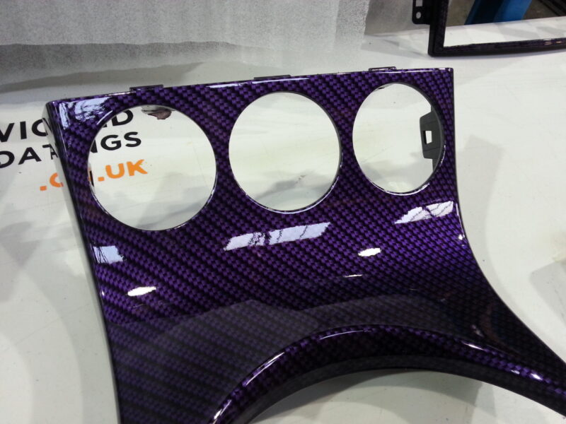 Car dashboard elements coated in carbon fibre hydrographic film painted purple