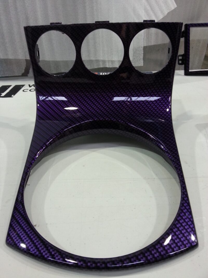 Car dashboard elements coated in carbon fibre hydrographic film painted purple