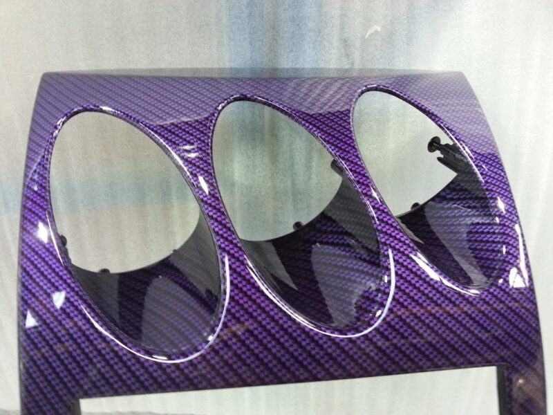 Car dashboard elements coated in carbon fibre hydrographic film painted purple