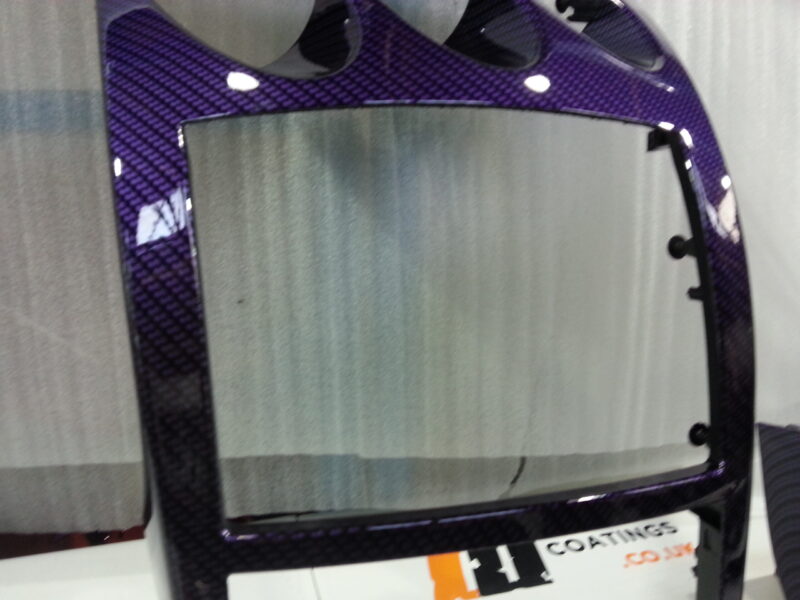 Car dashboard elements coated in carbon fibre hydrographic film painted purple