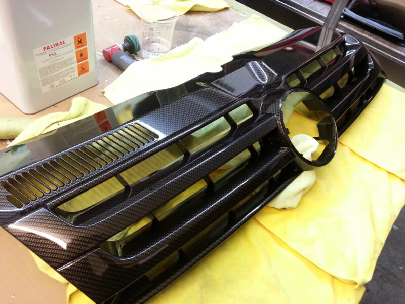VW radiator grill coated in carbon fibre hydrographic film painted black