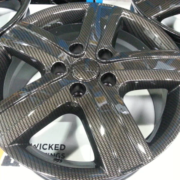 Car alloy wheels coated in carbon fibre hydrographic film painted black