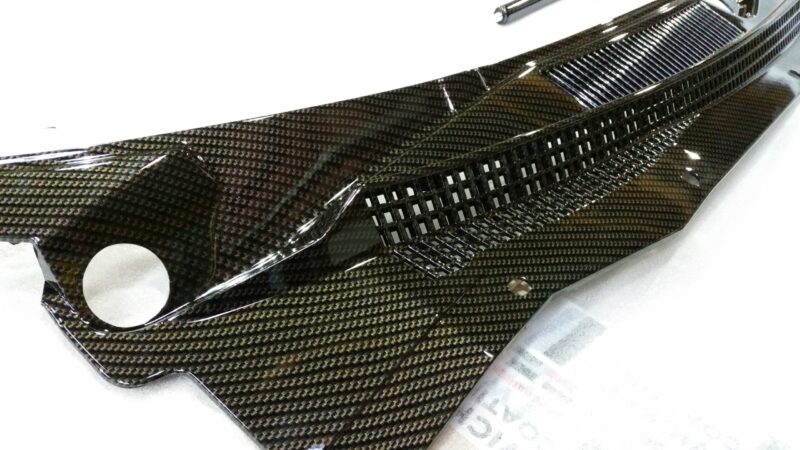 Car exterior element coated in carbon fibre
