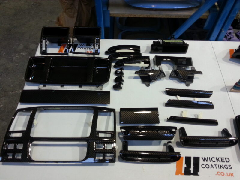 Car interior various elements coated in carbon fibre hydrographic film painted black