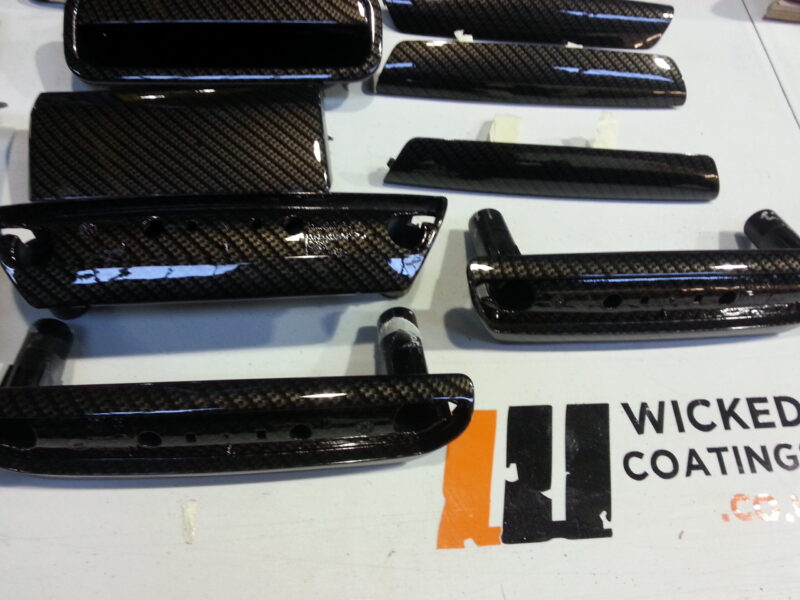 Car interior various elements coated in carbon fibre hydrographic film painted black