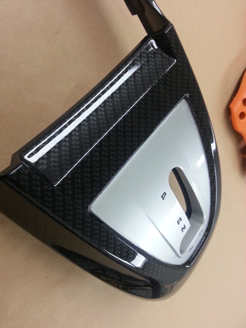 Car interior part coated in carbon fibre hydrographic film painted black