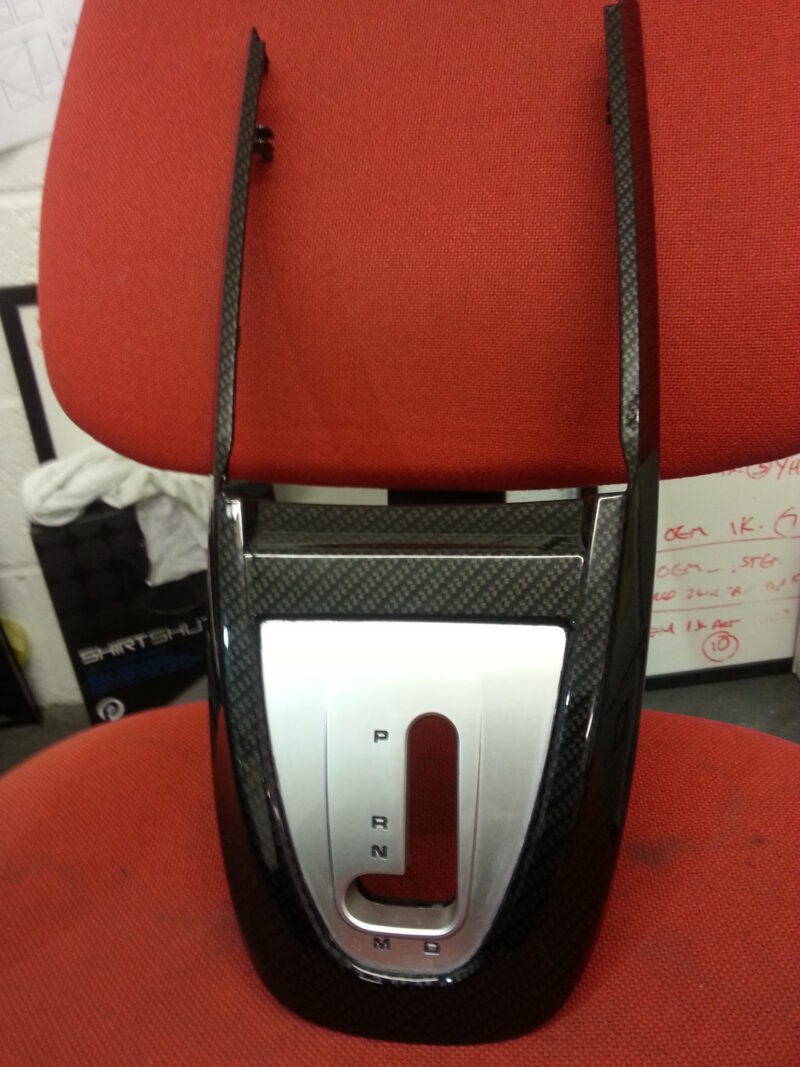 Car interior part coated in carbon fibre hydrographic film painted black