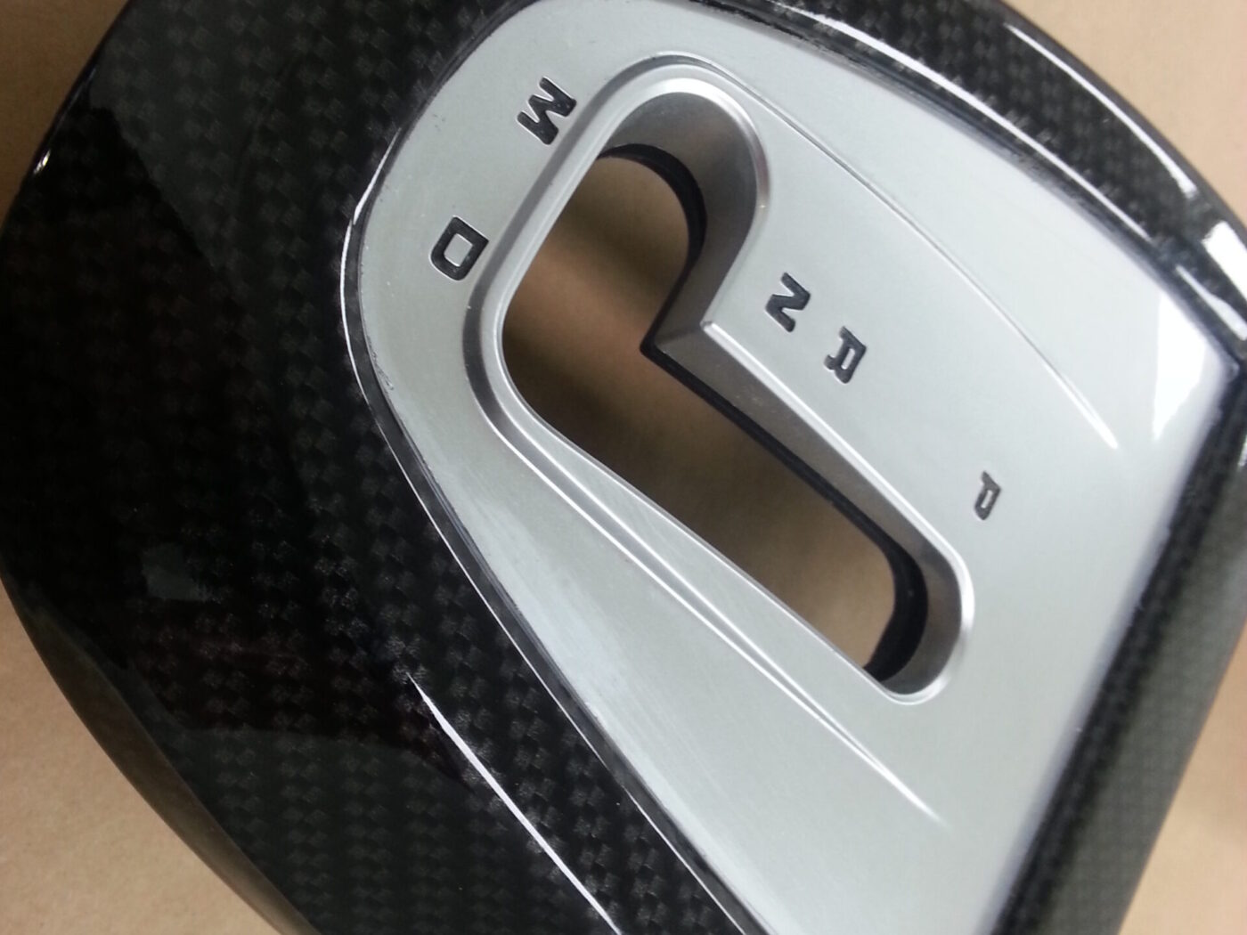 Car interior part coated in carbon fibre hydrographic film painted black