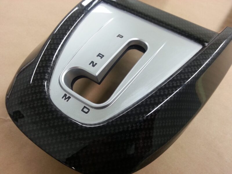 Car interior part coated in carbon fibre hydrographic film painted black