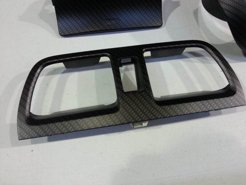 Car dashboard elements coat in carbon fibre hydrographic film painted black