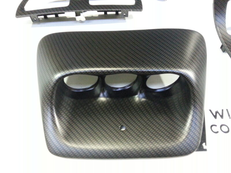 Car dashboard elements coat in carbon fibre hydrographic film painted black