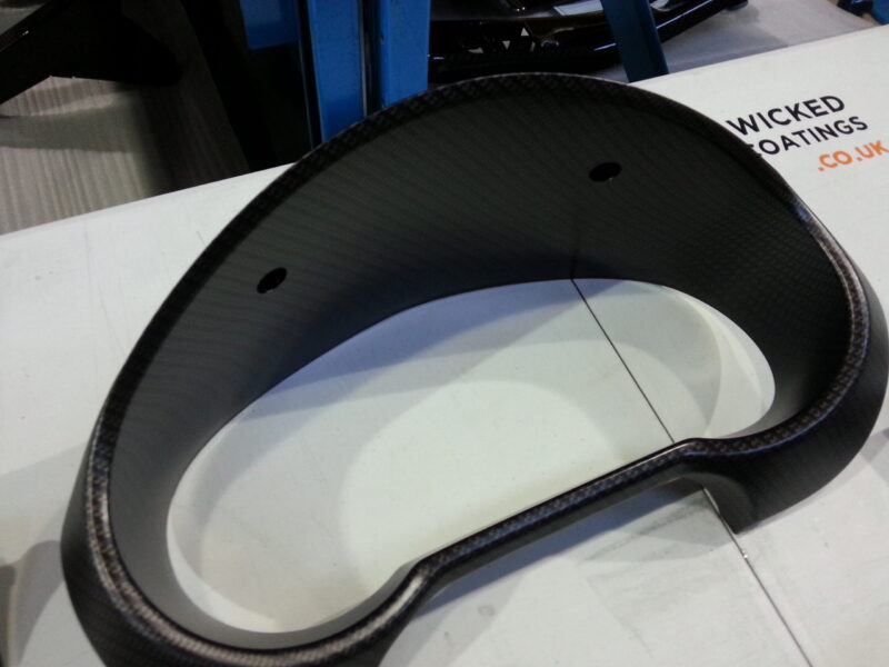Car dashboard elements coat in carbon fibre hydrographic film painted black