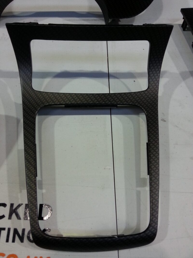 Car dashboard elements coat in carbon fibre hydrographic film painted black