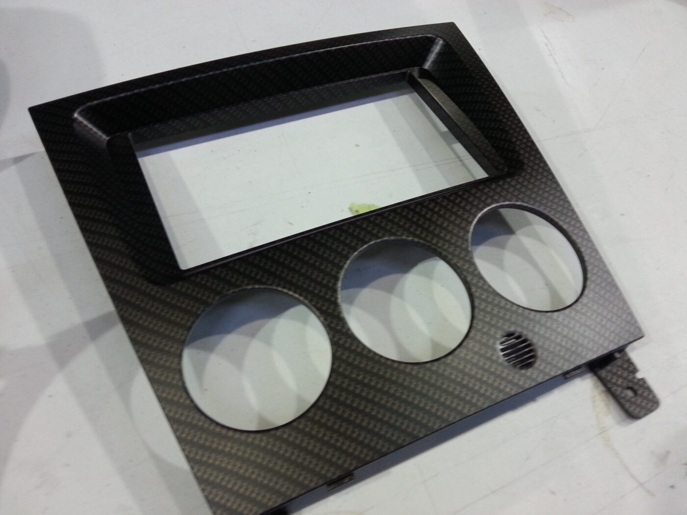 Car dashboard elements coat in carbon fibre hydrographic film painted black