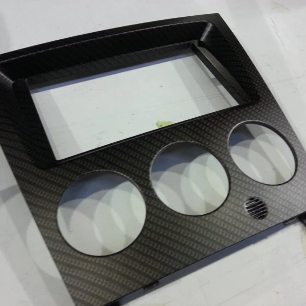Car dashboard elements coat in carbon fibre hydrographic film painted black