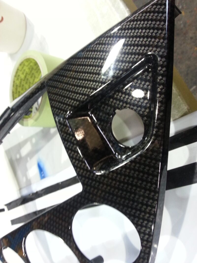 Car interior part coated in carbon fibre hydrographic film painted black