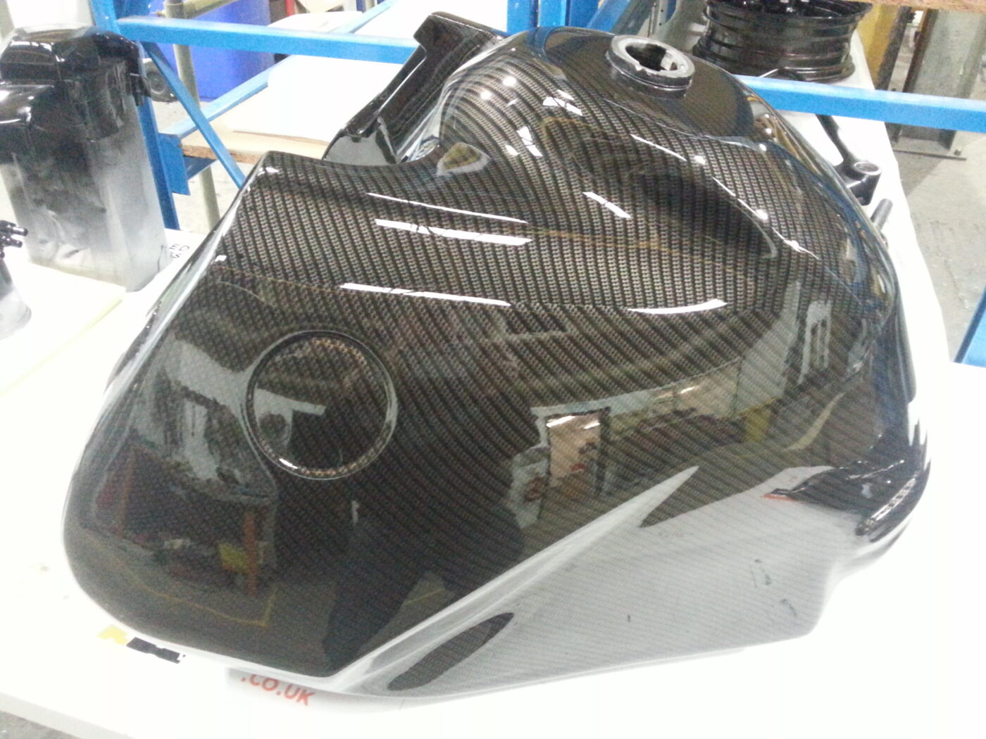 Motorbike tank coated in carbon fibre painted black