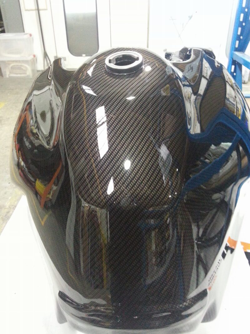 Motorbike tank coated in carbon fibre painted black