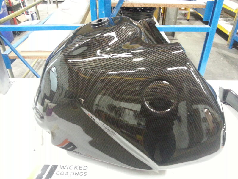 Motorbike tank coated in carbon fibre painted black