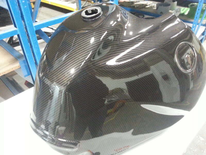 Motorbike tank coated in carbon fibre painted black