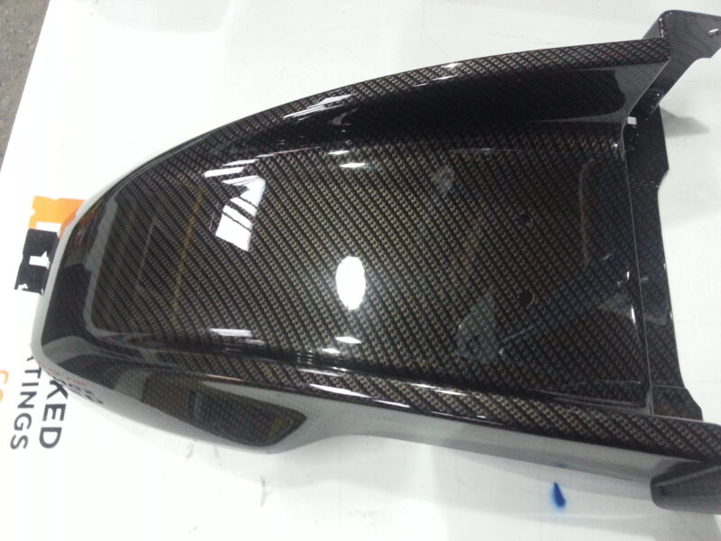 Motorbike tank coated in carbon fibre painted black