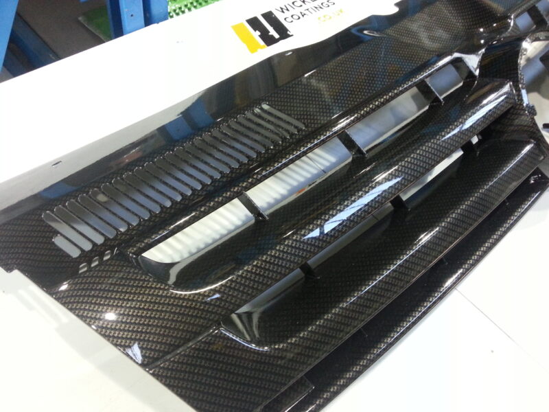 VW radiator grill coated in carbon fibre hydrographic film painted black