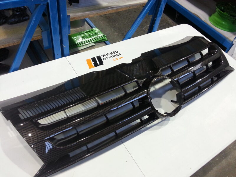 VW radiator grill coated in carbon fibre hydrographic film painted black