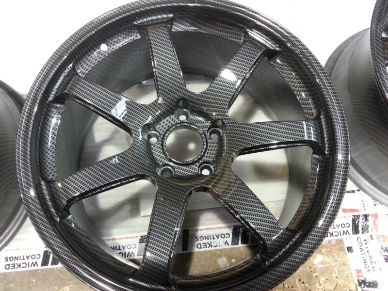 Car alloy wheels coated in carbon fibre hydrographic film painted grey