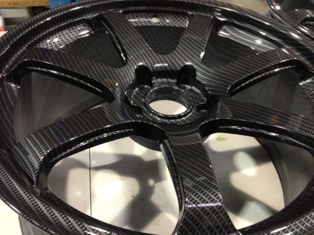 Car alloy wheels coated in carbon fibre hydrographic film painted grey