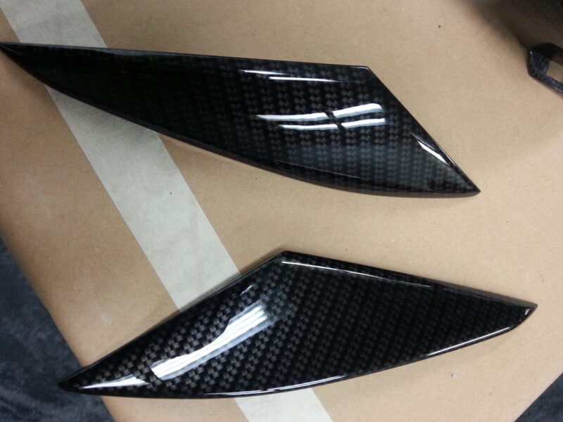 Motorbike parts coated in carbon fibre hydrographic film painted black