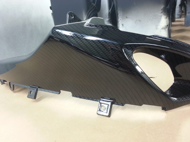 Motorbike parts coated in carbon fibre hydrographic film painted black