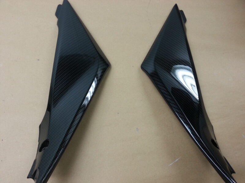 Motorbike parts coated in carbon fibre hydrographic film painted black