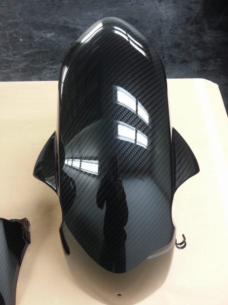 Motorbike parts coated in carbon fibre hydrographic film painted black