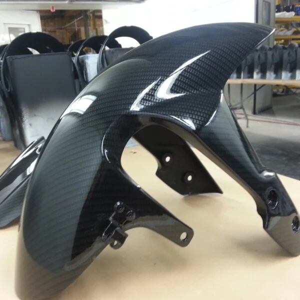 Motorbike parts coated in carbon fibre hydrographic film painted black