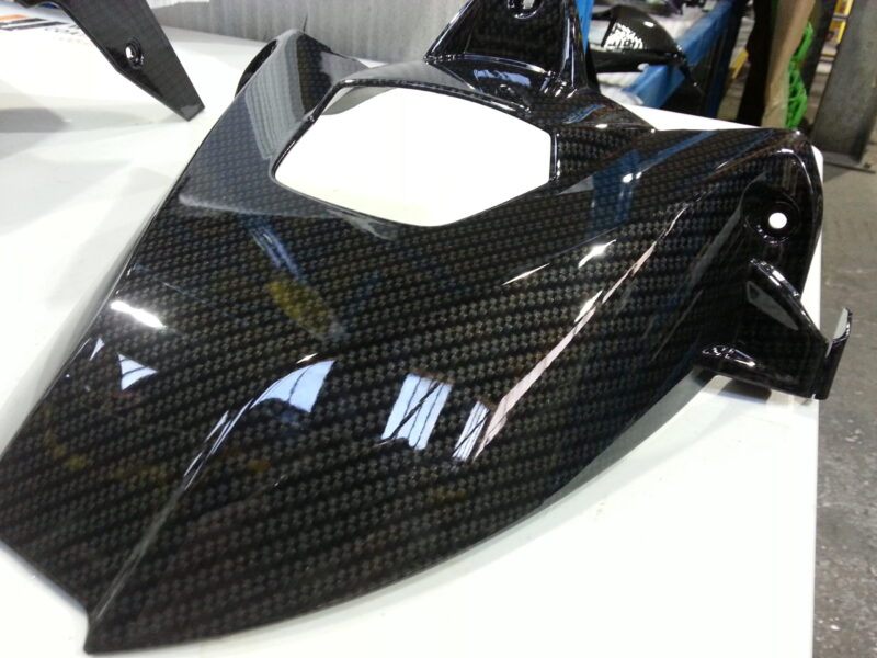 Motorbike parts coated in carbon fibre hydrographic film painted black