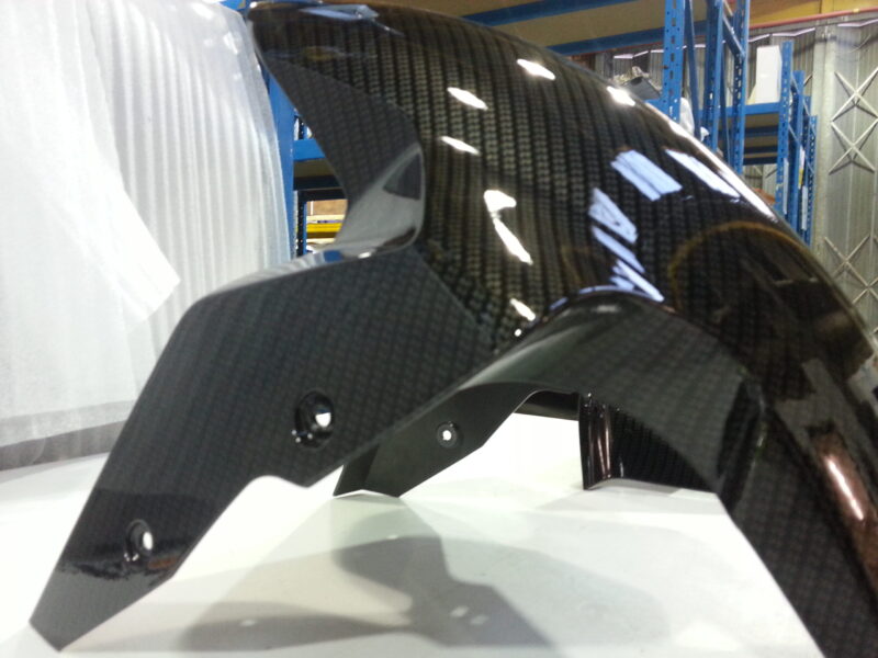 Motorbike parts coated in carbon fibre hydrographic film painted black