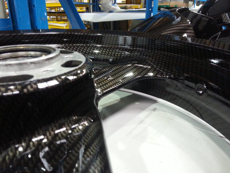 Motorbike parts coated in carbon fibre hydrographic film painted black