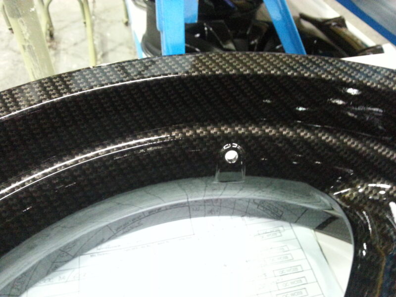 Motorbike parts coated in carbon fibre hydrographic film painted black