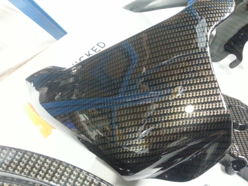 Motorbike parts coated in carbon fibre hydrographic film painted black