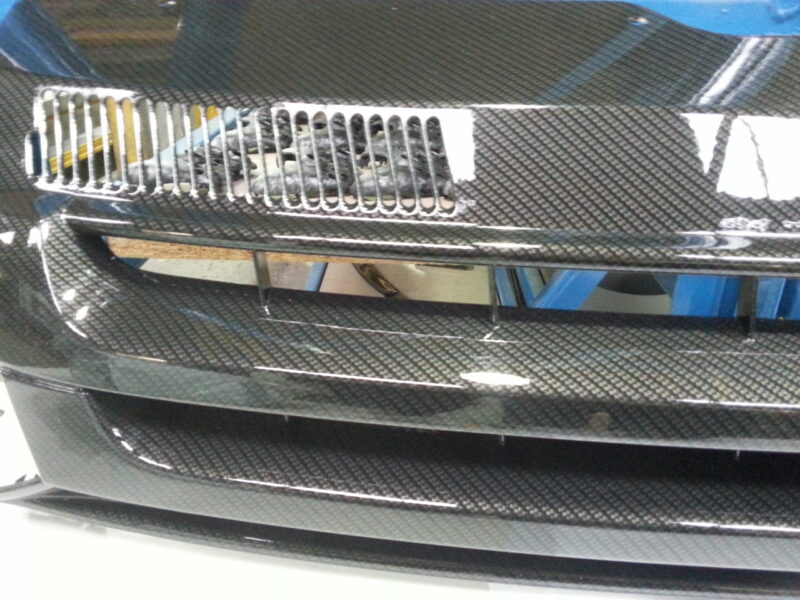 VW radiator grill coated in carbon fibre hydrographic film painted black