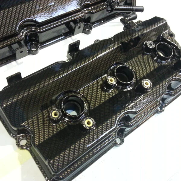 Car engine cover coated in carbon fibre hydrographic film painted black