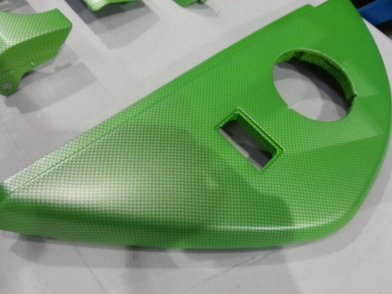 Car interior elements coated in carbon fibre painted green
