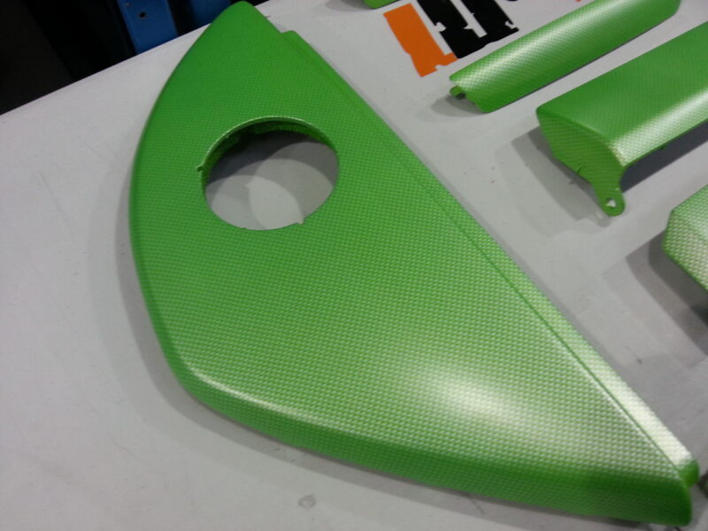 Car interior elements coated in carbon fibre painted green