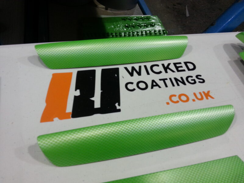 Car interior elements coated in carbon fibre painted green